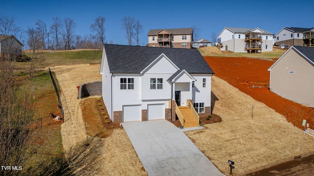 view of front of property with driveway, a residential view, roof with shingles, an attached garage, and brick siding