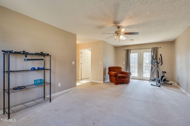 unfurnished room featuring a textured ceiling, ceiling fan, carpet flooring, and french doors