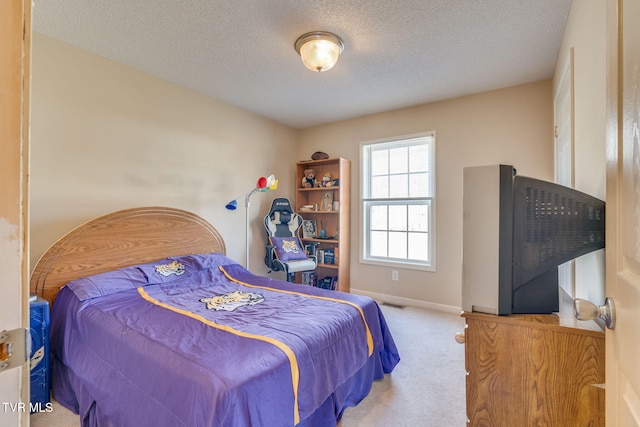 carpeted bedroom with a textured ceiling