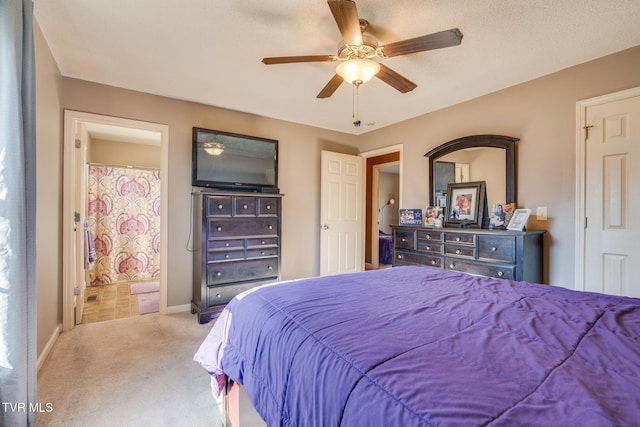 bedroom with ensuite bath, ceiling fan, and light carpet