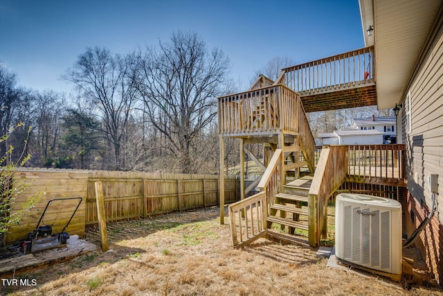 view of yard with central AC unit and a deck