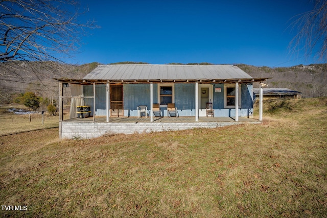 rear view of property with a yard