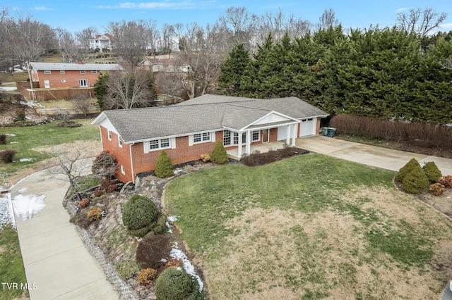 ranch-style house featuring a garage and a front yard