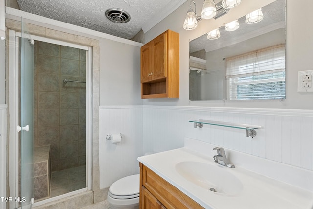 bathroom featuring a textured ceiling, toilet, an enclosed shower, and vanity