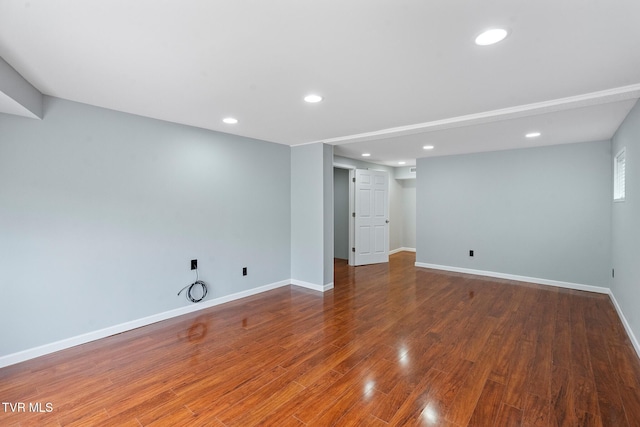 basement with hardwood / wood-style floors