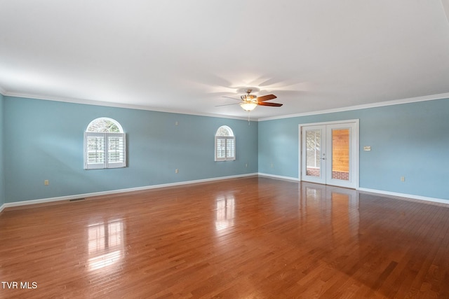 unfurnished room featuring ceiling fan, plenty of natural light, crown molding, and french doors