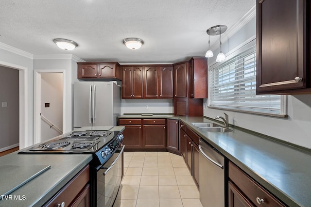 kitchen featuring decorative light fixtures, sink, crown molding, stainless steel appliances, and light tile patterned floors