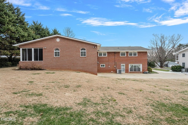 back of property with cooling unit, a yard, and a patio