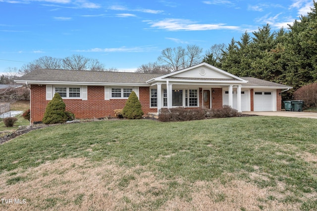 ranch-style house featuring a garage, a front yard, and covered porch