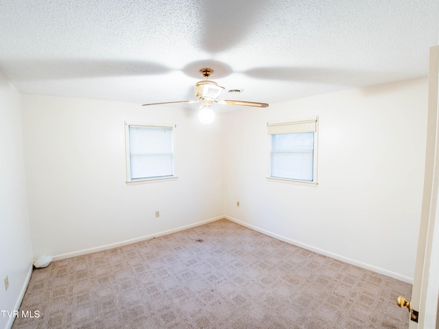 carpeted empty room featuring a textured ceiling