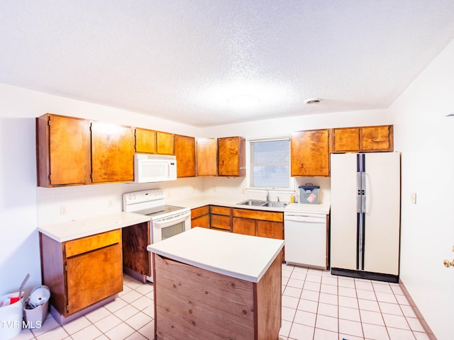 kitchen featuring white appliances, a textured ceiling, a center island, sink, and light tile patterned floors