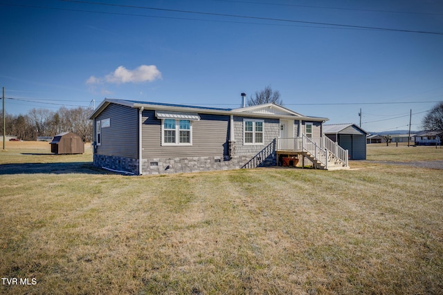 view of front of home featuring a front yard and a storage unit