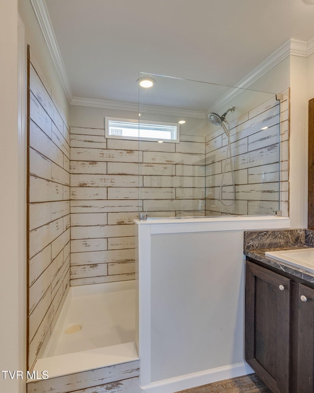 bathroom featuring ornamental molding, a shower, and vanity