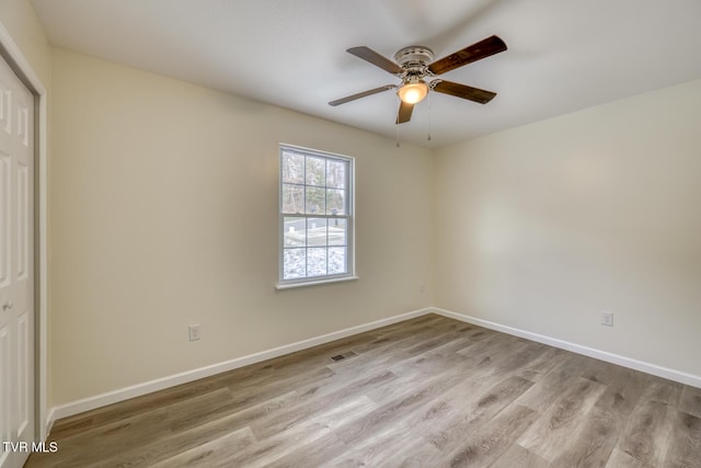 empty room with light wood-type flooring and ceiling fan