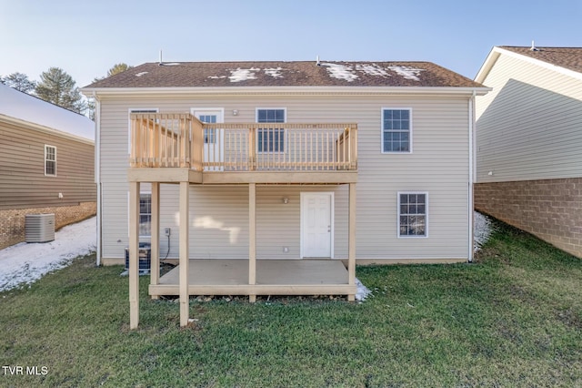 back of property featuring a wooden deck, a lawn, and a balcony