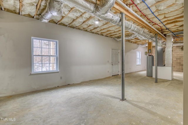 basement with gas water heater and a wealth of natural light