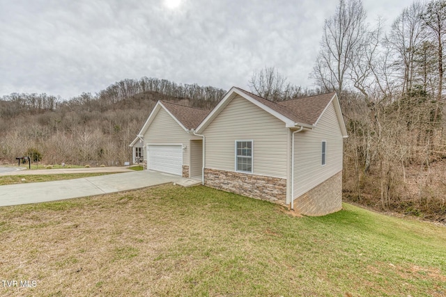 view of front of house with concrete driveway, a front yard, roof with shingles, a garage, and stone siding