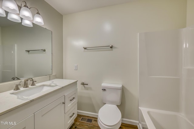 full bathroom with toilet, vanity, shower / washtub combination, and hardwood / wood-style flooring