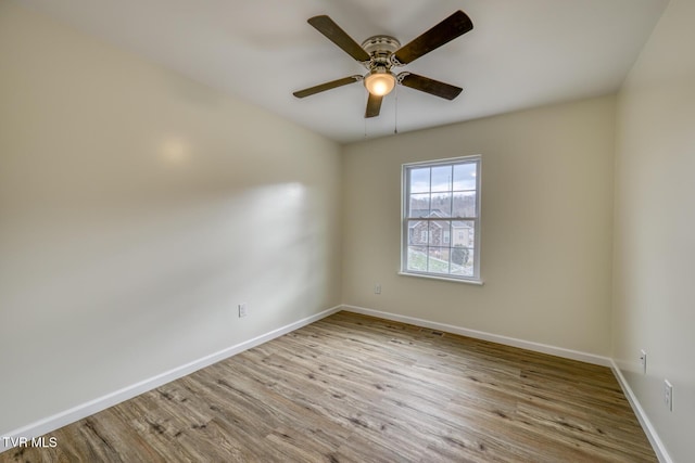 empty room with light wood-type flooring and ceiling fan