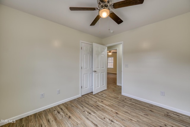 empty room featuring ceiling fan and light hardwood / wood-style floors