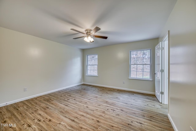 spare room with light wood-type flooring and ceiling fan