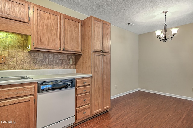 kitchen featuring pendant lighting, decorative backsplash, an inviting chandelier, white dishwasher, and dark wood-type flooring