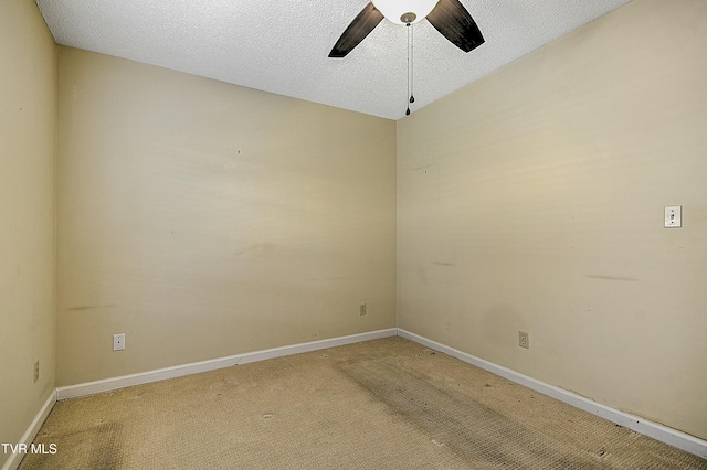 empty room with ceiling fan, carpet, and a textured ceiling