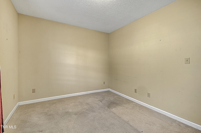 carpeted spare room with a textured ceiling