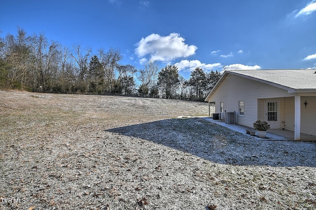 view of yard with a patio area and central AC