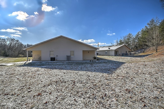 back of house with central AC