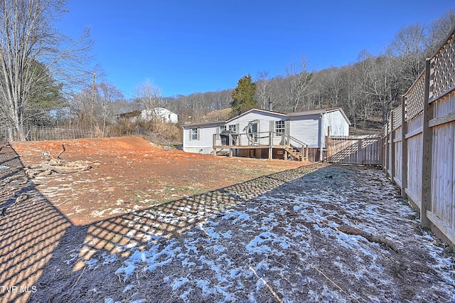 back of property featuring a wooden deck