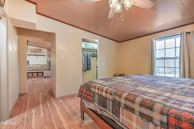 bedroom featuring ceiling fan, lofted ceiling, and light hardwood / wood-style flooring