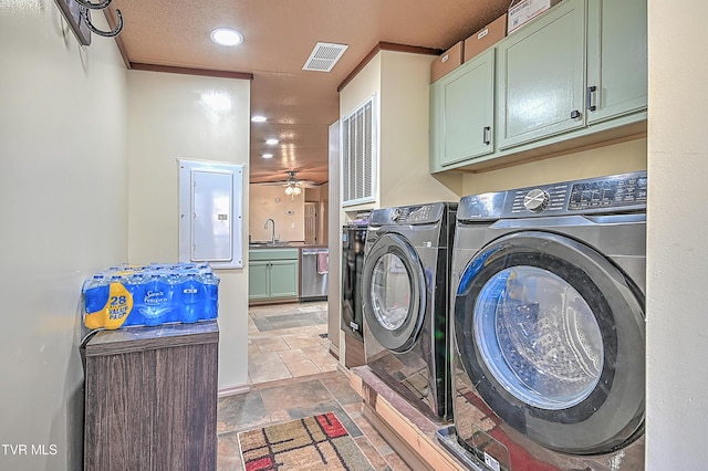 laundry area featuring sink, cabinets, electric panel, ceiling fan, and independent washer and dryer