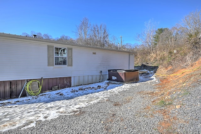 snow covered property featuring a hot tub