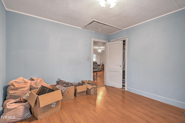 misc room featuring a textured ceiling and light hardwood / wood-style flooring