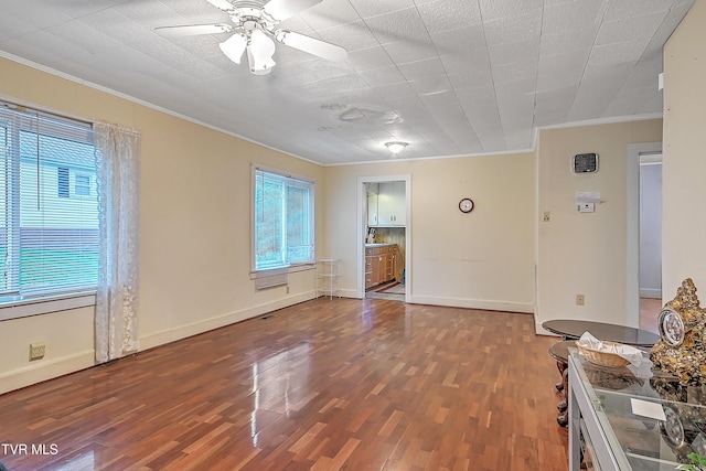 unfurnished room featuring hardwood / wood-style flooring, a wealth of natural light, ornamental molding, and ceiling fan