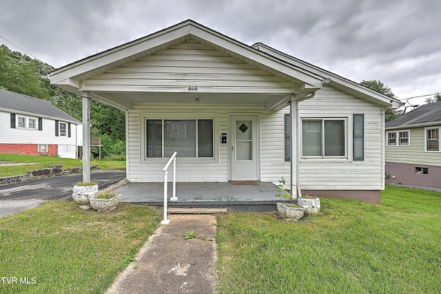 bungalow featuring a front lawn and a porch