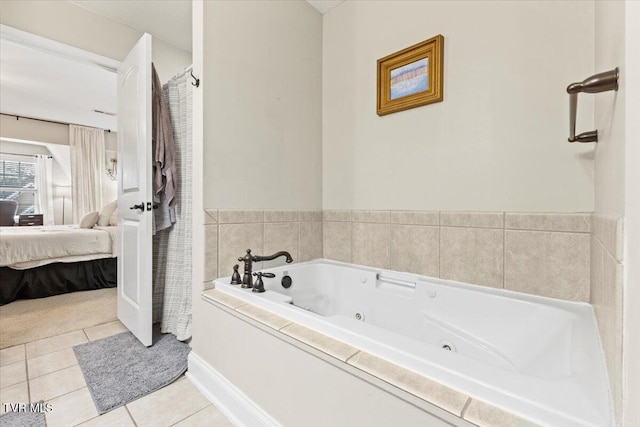 bathroom with a tub and tile patterned floors