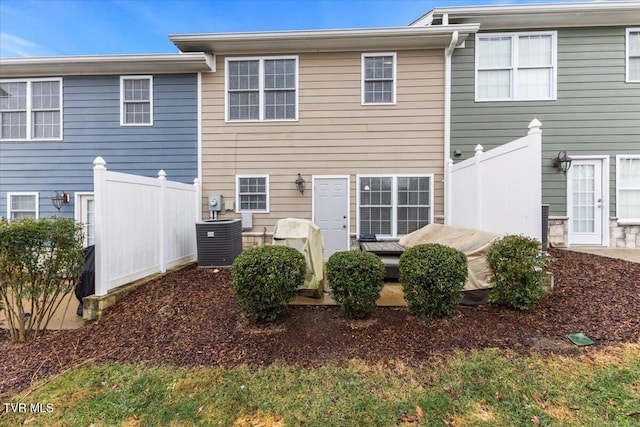 rear view of house featuring central AC unit