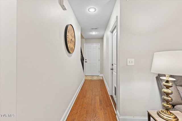 hall with hardwood / wood-style floors