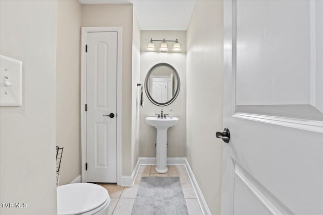 bathroom with tile patterned floors and toilet