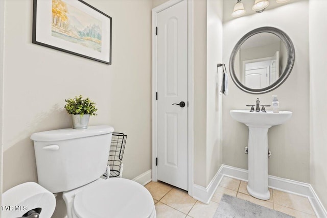 bathroom featuring toilet and tile patterned floors