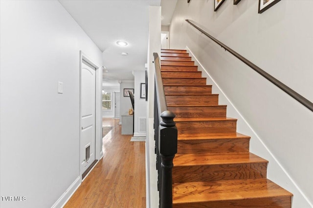 stairway featuring wood-type flooring