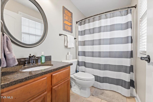 bathroom featuring toilet, vanity, tile patterned flooring, and a shower with curtain