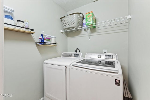 clothes washing area featuring washer and dryer