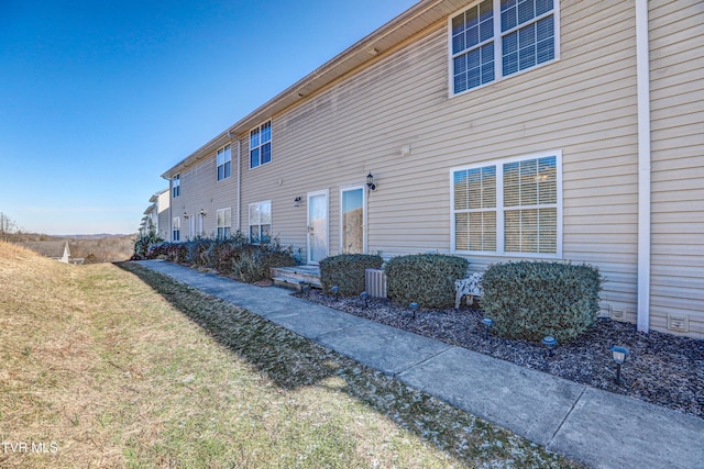 view of side of home featuring a yard