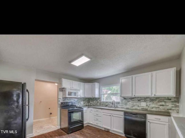 kitchen with white cabinetry, tasteful backsplash, a textured ceiling, black appliances, and sink