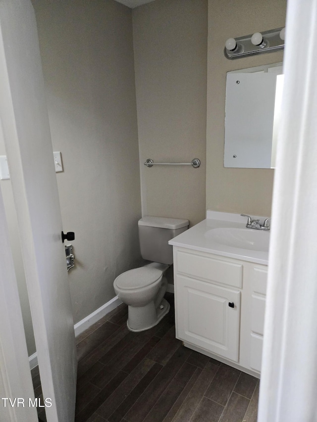 bathroom featuring hardwood / wood-style flooring, vanity, and toilet