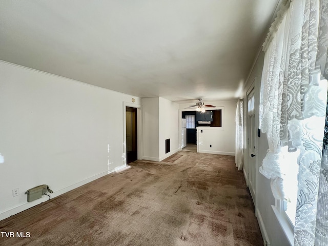 unfurnished living room with ceiling fan and carpet floors