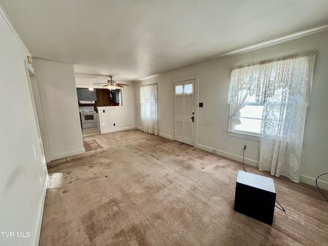 unfurnished living room with carpet floors and ceiling fan